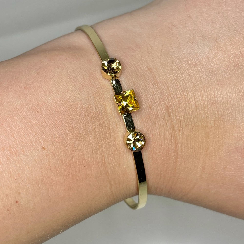 Bangle bracelet with topaz colored stones